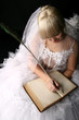 beautiful bride in white dress and wrote in old book