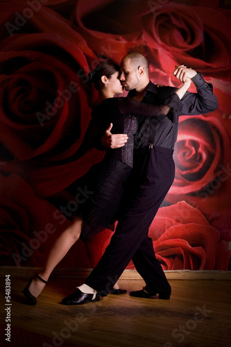 Photo: young couple in love at the nightclub dancing Latino dance young couple in love at the nightclub dancing Latino dance