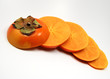 an orgainic fuyu persimmon sliced to show the internal star 