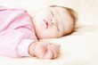 Sleeping baby in pink clothes
