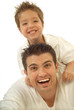 Young father and his toddler son playing around and laughing