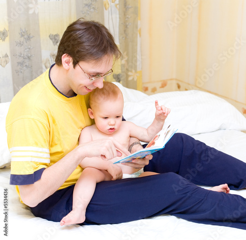 Photo: Father reading to his son Father reading to his son