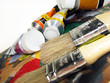 Paint brushes on palette with paint tubes