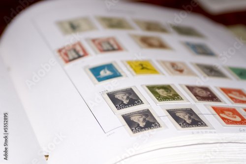 Photo: Old Dutch stamps in album. A few in focus the rest unfocussed Old Dutch stamps in album. A few in focus the rest unfocussed