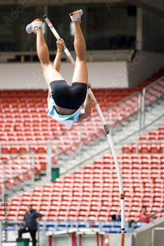 Photo: Image of a female pole vaulter in action. Image of a female pole vaulter in action.