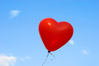 Red heart-shaped ballon with blue sky