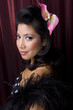 Female model with styled hair on red background.