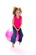 Foto: Young laughing girl bouncing on a pink space hopper Young laughing girl bouncing on a pink space hopper