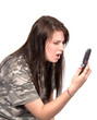 Teenager looking at cell phone with horrified expression