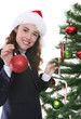 A woman hanging a Christmas ornament A woman hanging a Christmas ornament