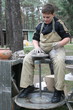 Young boy potter working with clay on wheel Young boy potter working with clay on wheel