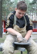 Young boy potter working with clay on wheel Young boy potter working with clay on wheel