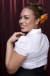 Latin pin-up model on red background.