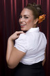Female model with styled hair on red background.