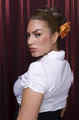 Female model with styled hair on red background.
