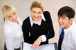 Image of three smiling business people looking at camera Image of three smiling business people looking at camera