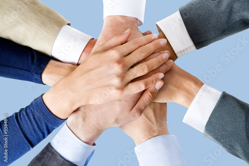 Photo: Photo of business people’s hands on top of each other Photo of business people’s hands on top of each other
