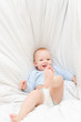 Little joyful baby fall on white bed Little joyful baby fall on white bed