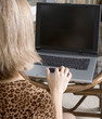 Looking over the shoulder of a young working woman