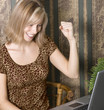 Young working woman happy to have found success on her laptop