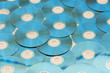 Many cd's arranged on the flat surface