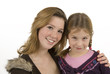 two cute sisters embracing against white background