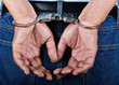 Man handcuffed hands at the back