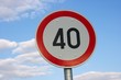 Speed limit traffic sign against blue sky