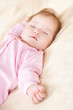 Sleeping baby in pink clothes