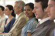 Young businesswoman in seated line of colleagues