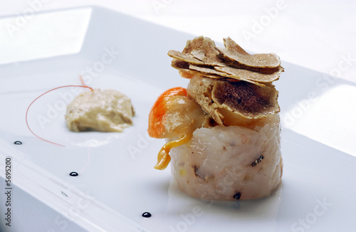 Rolled fish fillet and shell meat with truffle slices on top