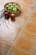Red and green apples over ceramic tiles