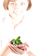 Image of woman holding the plant in her palm