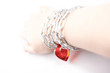 Female hand wound by a chain with heart