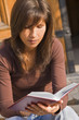 Image of a girl student reading something from a notebook. Image of a girl student reading something from a notebook.
