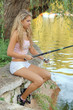 A beautiful young woman with a fishing pole A beautiful young woman with a fishing pole