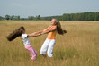 Girls plays on a meadow II