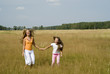 Girls plays on a meadow