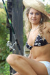 A beautiful young woman with a fishing pole A beautiful young woman with a fishing pole