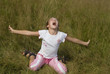 Girl plays on a meadow