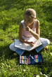 The girl draws on a meadow II