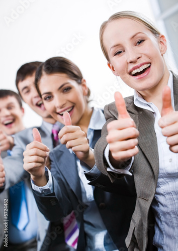 Vertical image of business people giving the thumbs-up sign