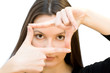 Portrait of young woman creates a frame with her hands. Portrait of young woman creates a frame with her hands.