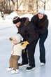 Photo: Winter recreation. Family skating on rink Winter recreation. Family skating on rink