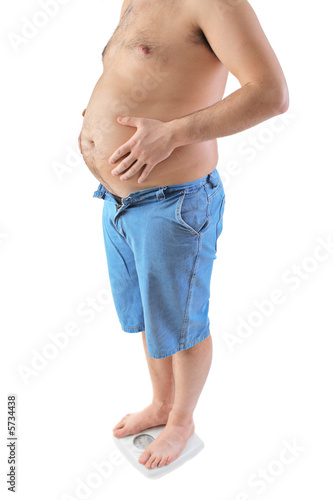 Fat man standing on a weight scale isolated on white
