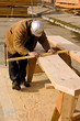 A craftsman laying out the cuts for a staircase stringer