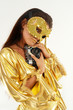 Sexy smiling girl in golden mask & dress with old photo camera. Sexy smiling girl in golden mask & dress with old photo camera.