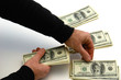 Photo: man counting out hunderd dollar bills in three stacks man counting out hunderd dollar bills in three stacks