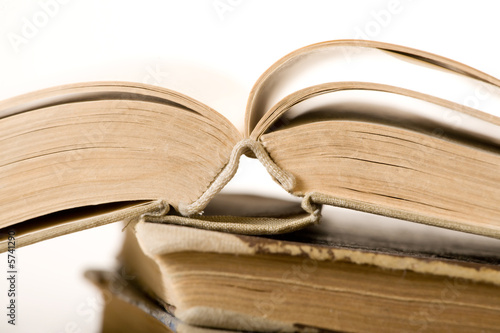 Opened old book. White background. Sepia tone. Shallow DOF.. Opened old book. White background. Sepia tone. Shallow DOF..
