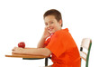 Young student at his desk, with a book and apple, ready to learn